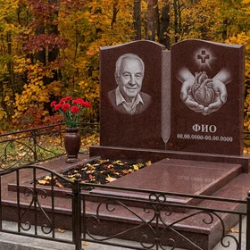 Гранитный памятник врачу в форме книги с чашей и змеёй